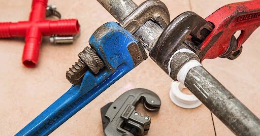 pipe wrenches attached to a newly connected pipe.