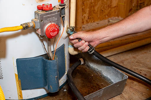 A water heater being maintained.