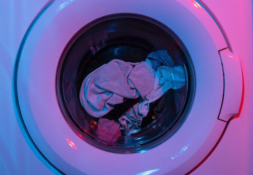 Clothes spinning inside a washing machine.