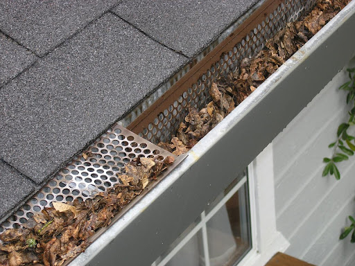Home gutters clogged with leaves.