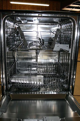 The stainless steel interior of a new dishwasher.