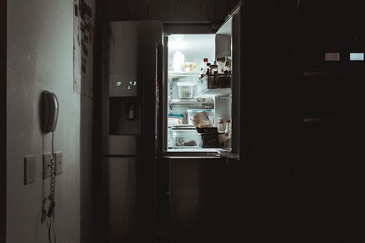 An open refrigerator in a kitchen.