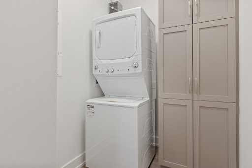 A stacked combination washer-dryer appliance.