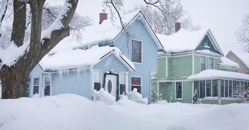 Houses covered in heavy snowfall.