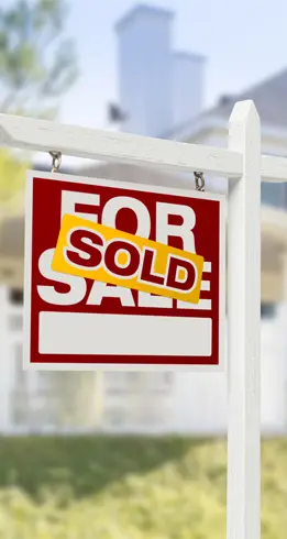 A sign indicating that a house that was for sale has now been sold.