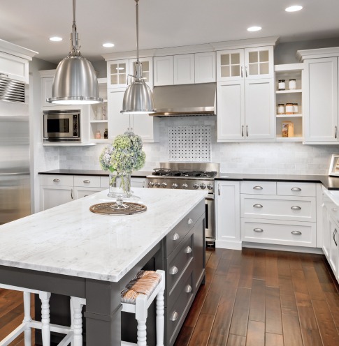 A large kitchen with modern stainless steel appliances.